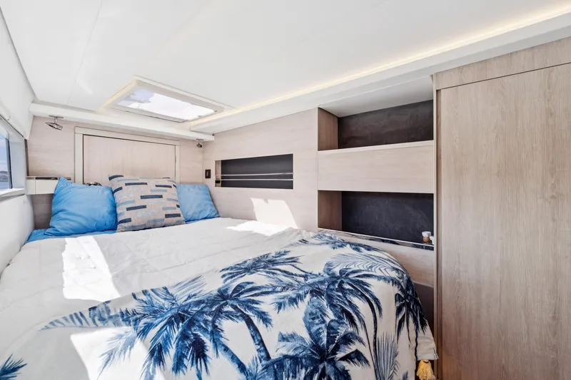 Always Wet Yacht Photos Pics Luxurious bedroom interior of 2021 Leopard 45 yacht with modern design and tropical bedding.