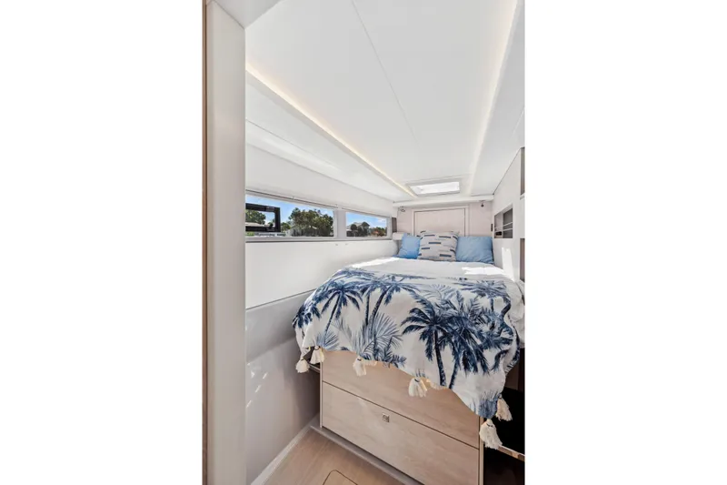 Always Wet Yacht Photos Pics Luxurious bedroom interior of 2021 Leopard 45 yacht with tropical-themed bedding.