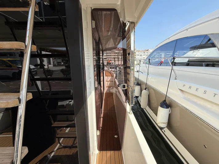 Cassiopee Yacht Photos Pics 2023 Beneteau Swift Trawler 41 Fly, side deck view with docked boats.