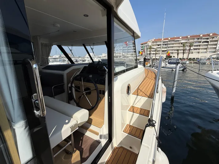 Cassiopee Yacht Photos Pics 2023 Beneteau Swift Trawler 41 Fly, showcasing helm and deck, docked at marina.