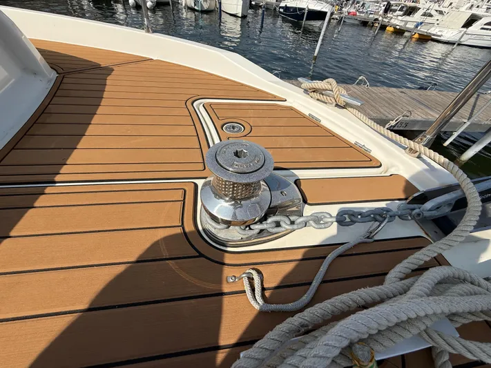 Cassiopee Yacht Photos Pics 2023 Beneteau Swift Trawler 41 Fly deck with winch and ropes at marina.