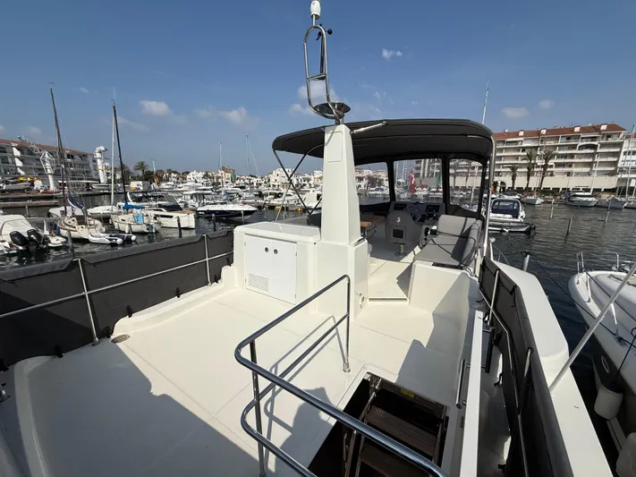 Cassiopee Yacht Photos Pics 2023 Beneteau Swift Trawler 41 Fly on marina, showcasing spacious deck and modern design.