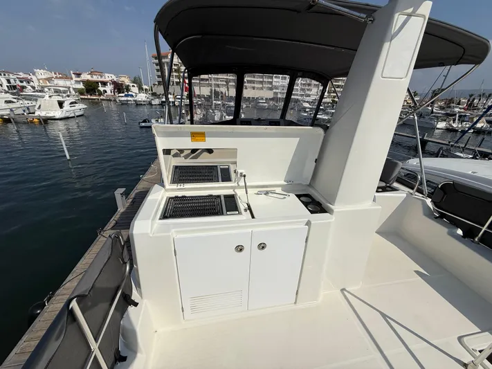 Cassiopee Yacht Photos Pics 2023 Beneteau Swift Trawler 41 Fly with outdoor kitchen on deck, docked at marina.