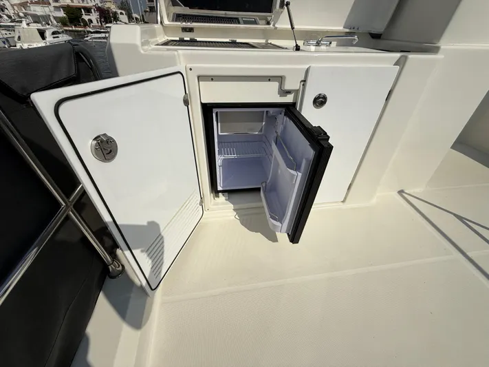 Cassiopee Yacht Photos Pics Open mini fridge on 2023 Beneteau Swift Trawler 41 Fly yacht deck.