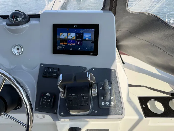 Cassiopee Yacht Photos Pics Control panel of 2023 Beneteau Swift Trawler 41 Fly with touchscreen and navigation controls.
