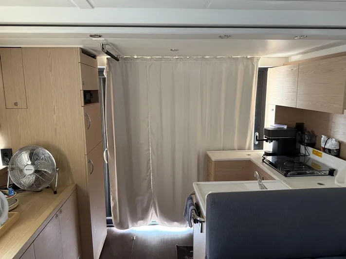 Cassiopee Yacht Photos Pics Interior of 2023 Beneteau Swift Trawler 41 Fly, featuring kitchen and curtain.