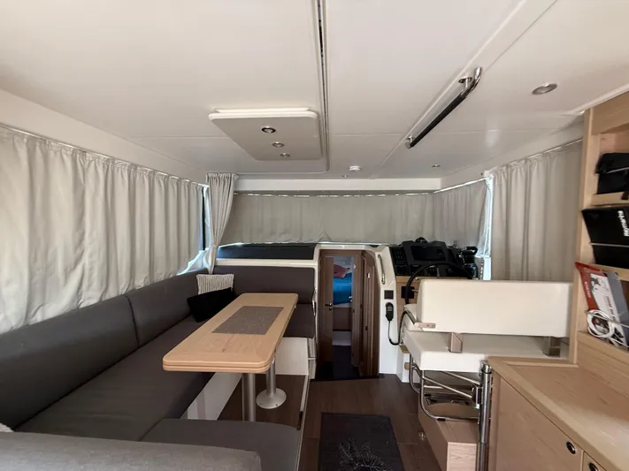 Cassiopee Yacht Photos Pics Interior of 2023 Beneteau Swift Trawler 41 Fly, featuring modern seating and navigation area.