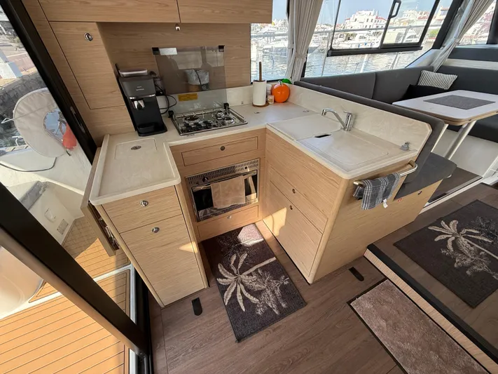 Cassiopee Yacht Photos Pics Modern kitchen in 2023 Beneteau Swift Trawler 41 Fly, featuring sleek cabinetry and appliances.