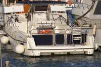 2002 Quer 32 Fish Cuddy boat docked in a marina, rear view.