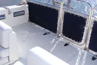 2002 Quer 32 Fish Cuddy boat deck with cushioned seating and stainless steel railings.