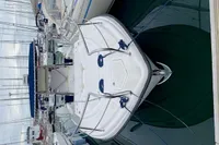 2002 Quer 32 Fish Cuddy boat docked in a marina.