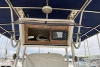 2002 Quer 32 Fish Cuddy boat dashboard with storage and electronic display.