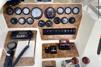 Control panel of a 2002 Quer 32 Fish Cuddy boat with gauges and switches.