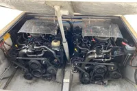 Twin engines in a 2002 Quer 32 Fish Cuddy boat, showcasing detailed mechanical components.
