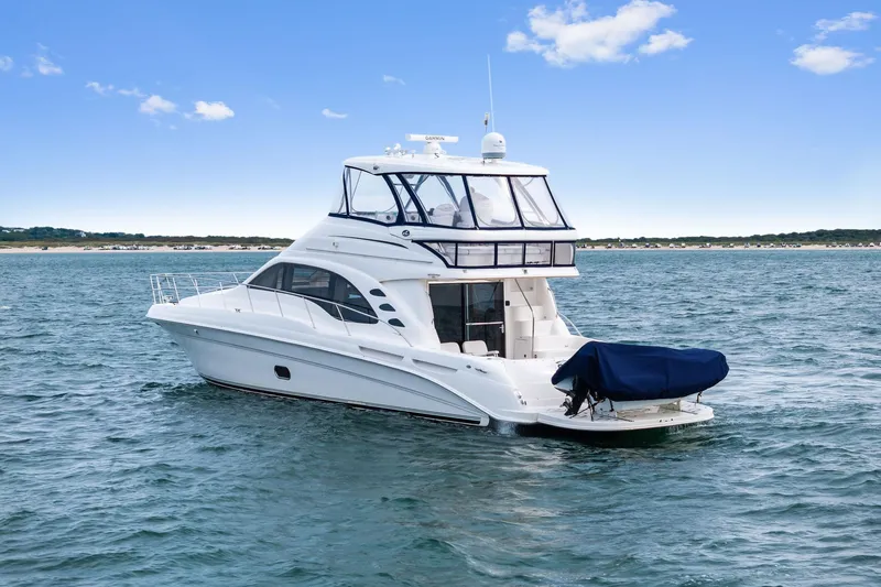 Sea-dels Yacht Photos Pics 2007 Sea Ray 58 Sedan Bridge yacht on open water under blue sky.