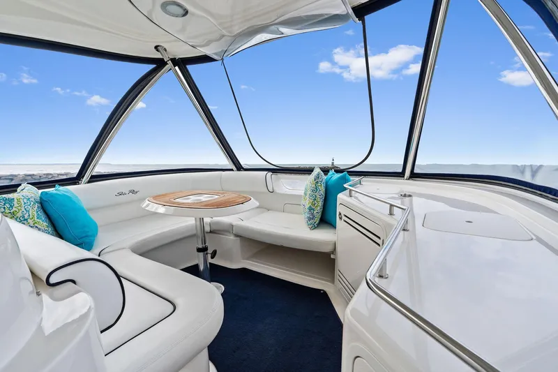 Sea-dels Yacht Photos Pics Luxurious interior of 2007 Sea Ray 58 Sedan Bridge yacht with elegant seating and table.