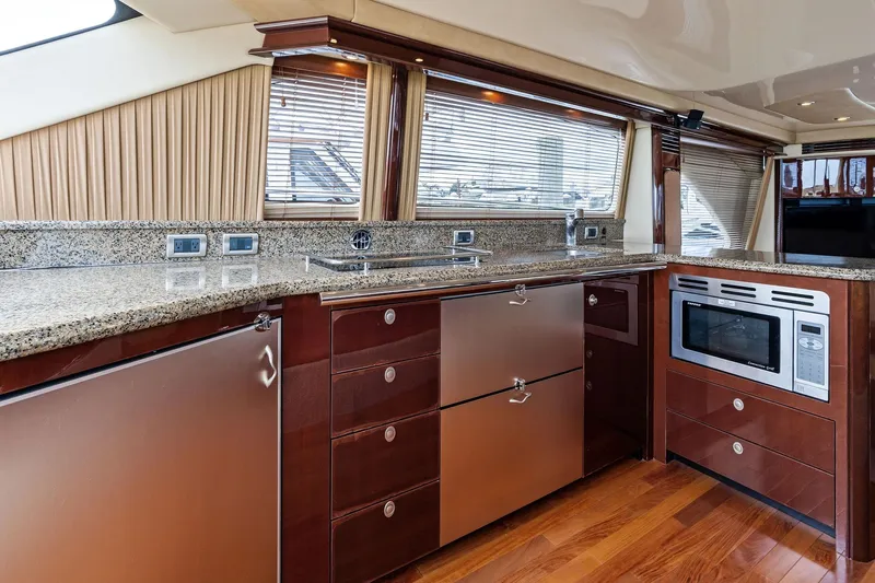 Sea-dels Yacht Photos Pics Luxurious kitchen interior of 2007 Sea Ray 58 Sedan Bridge yacht with modern appliances.