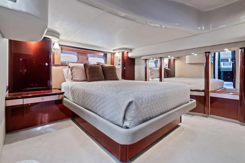 Sea-dels Yacht Photos Pics Luxurious bedroom interior of 2007 Sea Ray 58 Sedan Bridge yacht, featuring elegant design and cozy bedding.