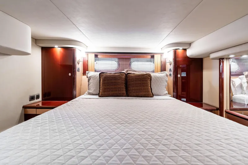 Sea-dels Yacht Photos Pics Luxurious bedroom interior of 2007 Sea Ray 58 Sedan Bridge yacht with elegant wood finishes.