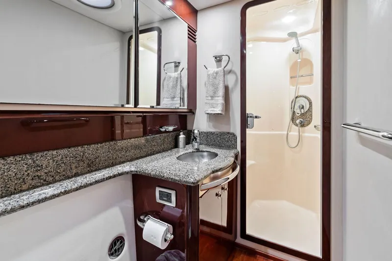 Sea-dels Yacht Photos Pics Luxurious bathroom in 2007 Sea Ray 58 Sedan Bridge yacht with granite countertop and shower.