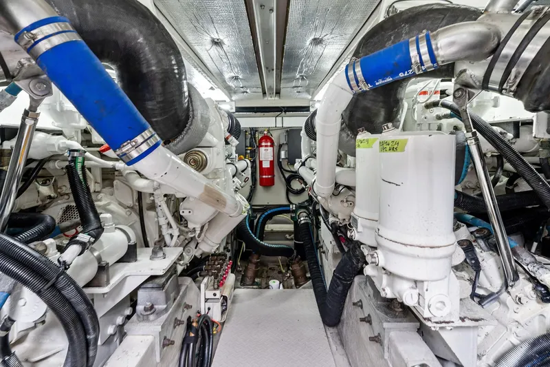 Sea-dels Yacht Photos Pics Engine room of 2007 Sea Ray 58 Sedan Bridge with visible machinery and fire extinguisher.