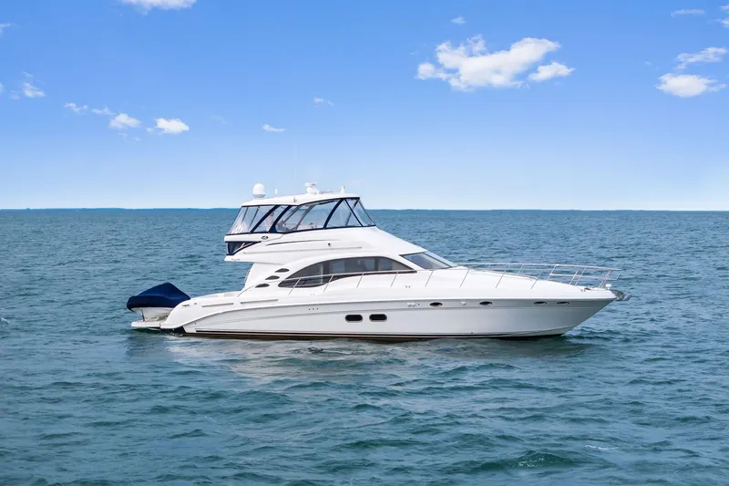 Sea-dels Yacht Photos Pics 2007 Sea Ray 58 Sedan Bridge yacht cruising on open water under clear blue sky.