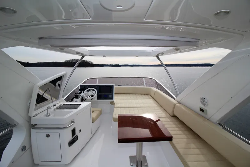 Raven Yacht Photos Pics Luxurious 2014 Azimut 54 Fly Bridge yacht interior with elegant seating and scenic water view.