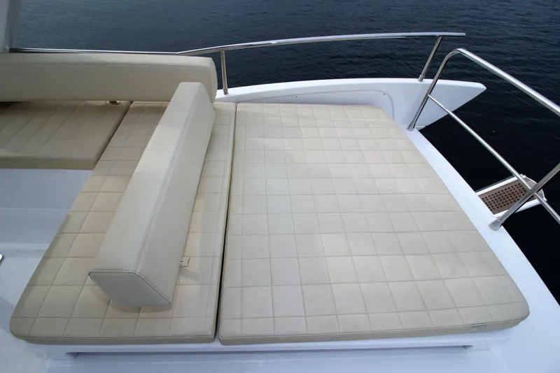 Raven Yacht Photos Pics Luxurious seating on 2014 Azimut 54 Fly Bridge yacht, overlooking serene water.