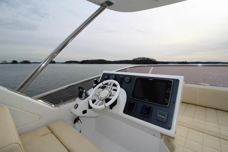 Raven Yacht Photos Pics Flybridge helm of 2014 Azimut 54 Fly Bridge yacht with scenic water view.