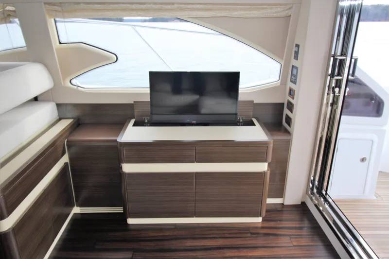 Raven Yacht Photos Pics Luxurious interior of 2014 Azimut 54 Fly Bridge yacht with modern TV and wood finish.
