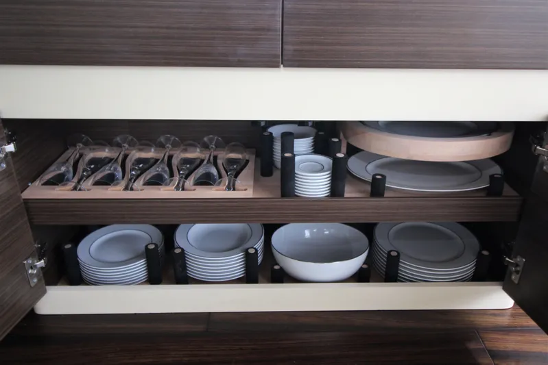 Raven Yacht Photos Pics Luxury yacht Azimut 54 Fly Bridge 2014 interior with organized dishware and glassware storage.