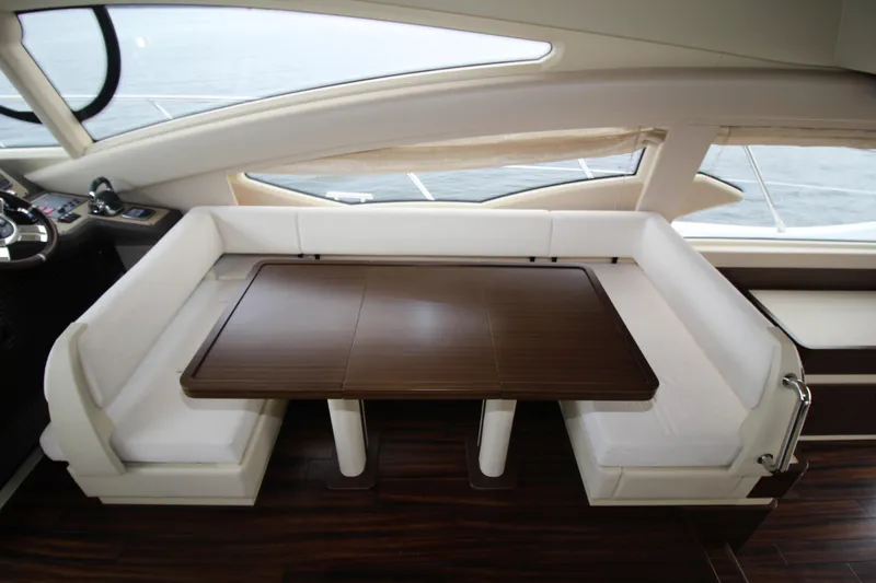 Raven Yacht Photos Pics Luxurious interior of 2014 Azimut 54 Fly Bridge yacht with elegant seating and wooden table.