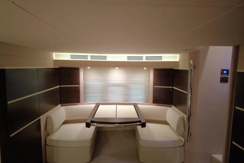 Raven Yacht Photos Pics Luxurious interior of 2014 Azimut 54 Fly Bridge yacht with elegant seating and table.