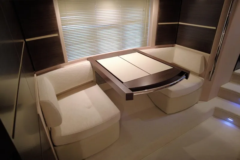 Raven Yacht Photos Pics Luxurious interior of 2014 Azimut 54 Fly Bridge yacht with elegant seating and table.