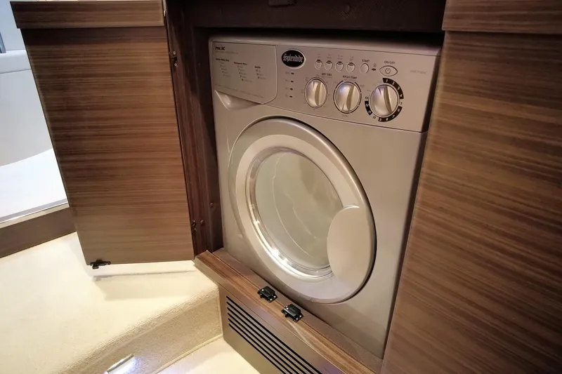 Raven Yacht Photos Pics Washing machine inside 2014 Azimut 54 Fly Bridge yacht's wooden cabinet.