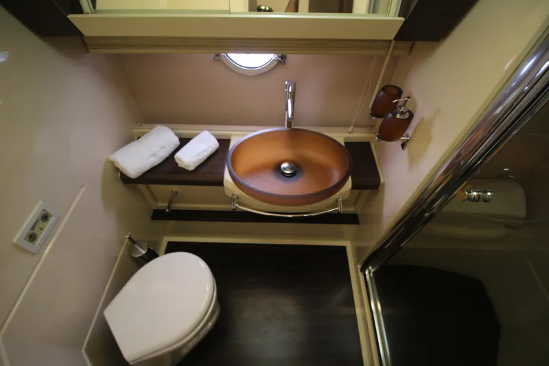 Raven Yacht Photos Pics Luxurious bathroom in 2014 Azimut 54 Fly Bridge yacht with modern sink and shower.