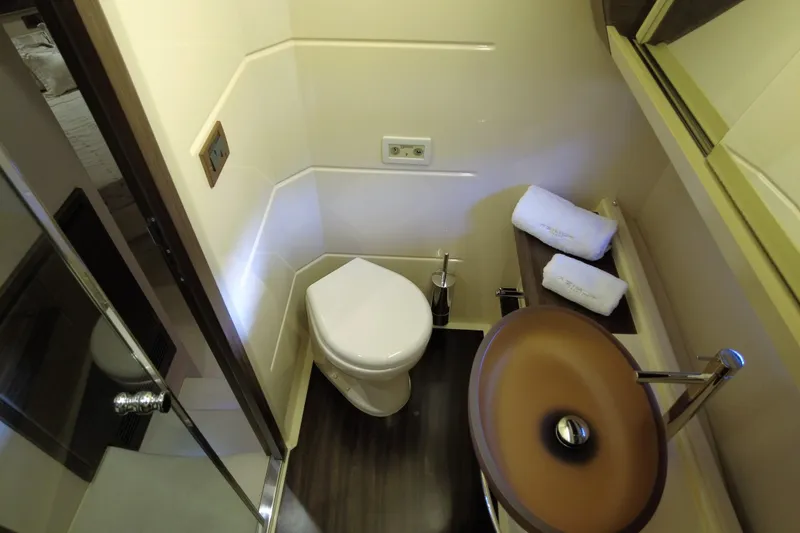 Raven Yacht Photos Pics Luxurious bathroom in 2014 Azimut 54 Fly Bridge yacht with modern fixtures.