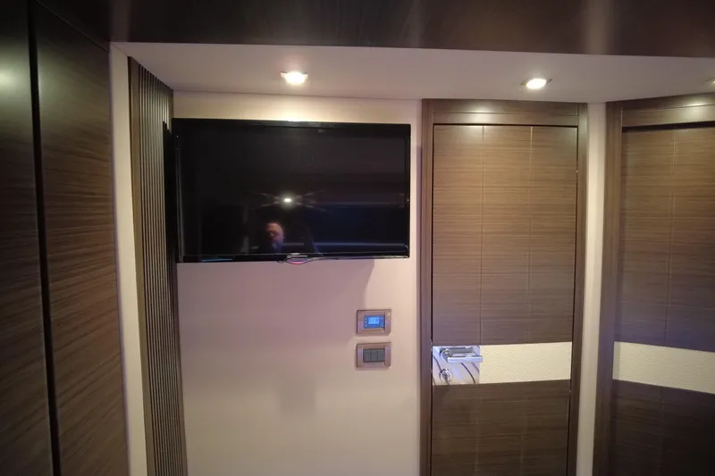 Raven Yacht Photos Pics Interior of 2014 Azimut 54 Fly Bridge yacht with mounted TV and modern wood paneling.