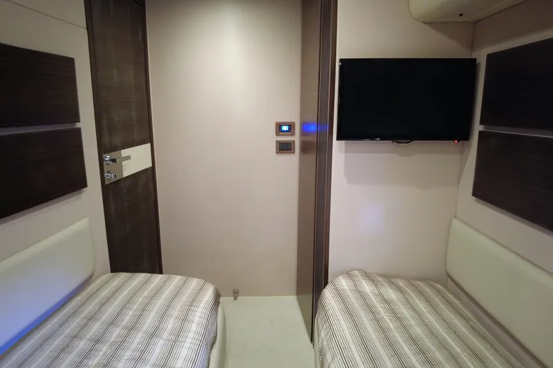 Raven Yacht Photos Pics Luxurious 2014 Azimut 54 Fly Bridge cabin with twin beds and wall-mounted TV.