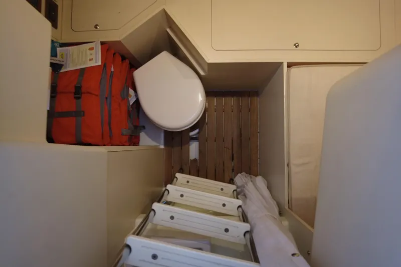 Raven Yacht Photos Pics Compact storage area in 2014 Azimut 54 Fly Bridge yacht with ladder and equipment.