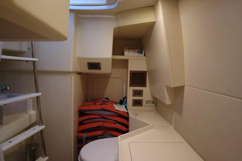 Raven Yacht Photos Pics 2014 Azimut 54 Fly Bridge yacht interior with life jackets and compact storage.