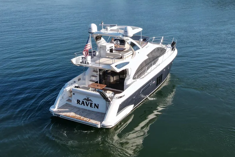 Raven Yacht Photos Pics Luxurious 2014 Azimut 54 Fly Bridge yacht cruising on calm waters.