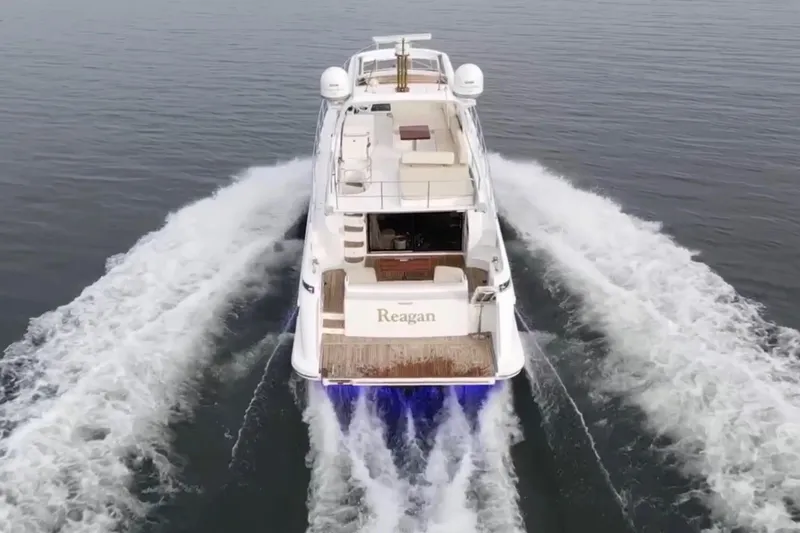 Raven Yacht Photos Pics Azimut 54 Fly Bridge 2014 yacht cruising on open water, rear view.