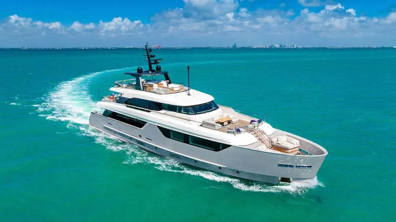 The Wolf Yacht Photos Pics Luxurious 2023 Sanlorenzo SD118 yacht cruising on turquoise waters under a clear blue sky.