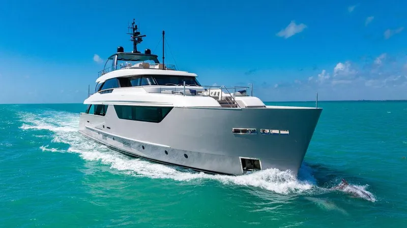 The Wolf Yacht Photos Pics 2023 Sanlorenzo SD118 yacht cruising on turquoise waters under a clear blue sky.