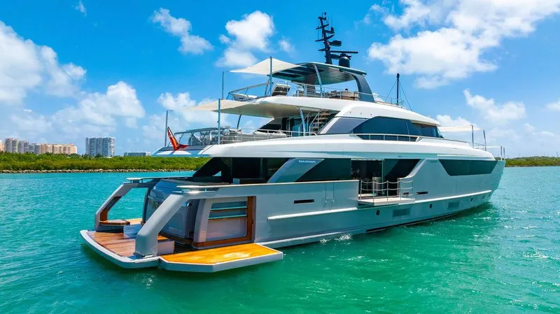 The Wolf Yacht Photos Pics Luxurious 2023 Sanlorenzo SD118 yacht cruising on turquoise waters under a clear blue sky.