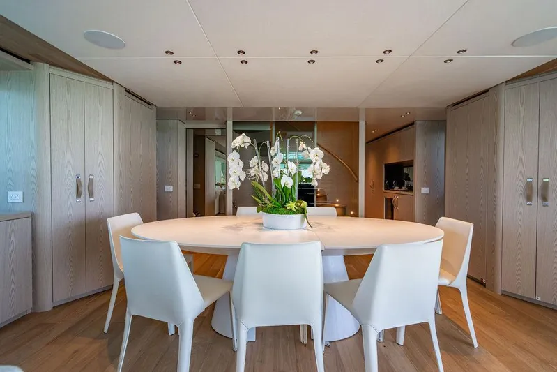 The Wolf Yacht Photos Pics Elegant dining area on 2023 Sanlorenzo SD118 yacht with modern decor and white chairs.
