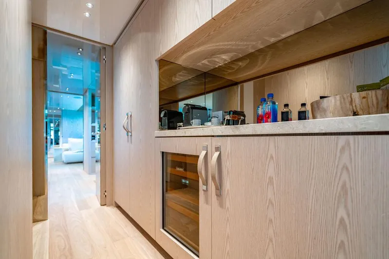 The Wolf Yacht Photos Pics Luxurious interior of 2023 Sanlorenzo SD118 yacht with modern kitchenette and sleek design.