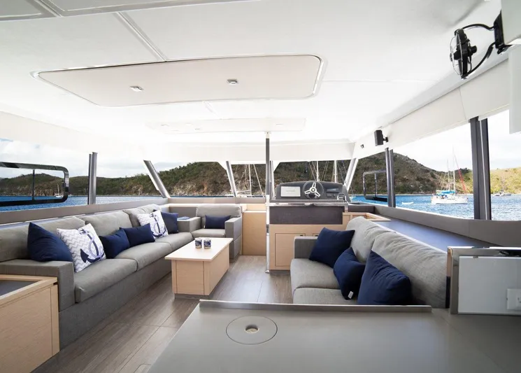 Wild Blue Yacht Photos Pics Luxurious interior of 2019 Fountaine Pajot MY 44 yacht with elegant seating and scenic views.