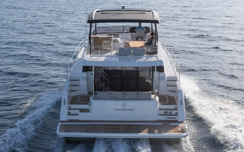 Wild Blue Yacht Photos Pics 2019 Fountaine Pajot MY 44 yacht cruising on open water, rear view.
